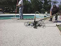 Pebble-Flex System can be finished with a power trowel to smooth the surface.