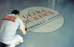 Concrete Solutions creates a visual appealing logo on a concrete floor.