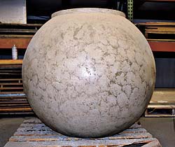 Buddy Rhodes Studio ball shaped concrete vase for outside plants.