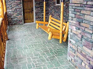 Stencil Systems designed a tile look pattern for this stone cabin's front porch. Multi colored overlay material was used to give the stencil work depth.