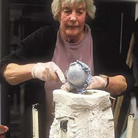 Carole Vincent working with concrete to create art.