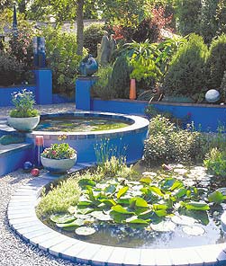 Carole Vincent constructed a brilliant blue tiered garden pond using concrete, bricks and round stone.