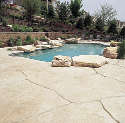 A pool deck that was created to look like natural slate stones but holds up better because they are made of concrete.