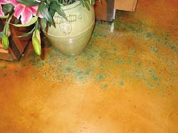 Blue and green speckled floor by ColorMaker Floors created using a concrete overlay and concrete stain.