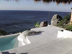 Pure white concrete overlay is a bright addition to a pool deck.