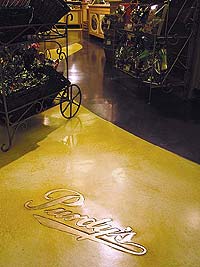 Colormaker Floors - Purdy's logo in a grocery store made of a concrete overlay.