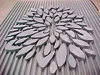Abstract flower with lined wall in concrete made by using a concrete formliner. Decorative forms by Greenstreak Inc.