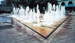 Patio fountains have hidden drains that catch the run off and recycle the water to the pump.