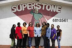 The SuperStone crew poses together in front of the SuperStone logo