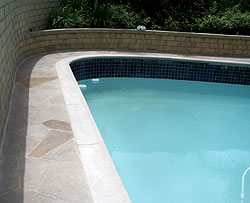 Decorating the edge of the pool is a great way to add life to any old pool surround.