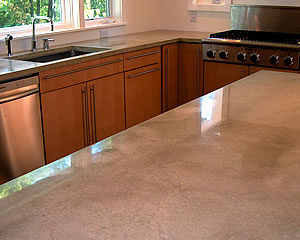 Gray concrete countertop that is precast and finished with a shiny sealer.