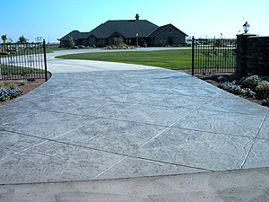 Carlton, whose work has been featured on televisions Extreme Makeover: Home Edition, says you can also take a design on the house and extend it out to draw the eye in. By deeply scoring the concrete, for example, he created a driveway whose design was an extension of the grid pattern found on the garage door.