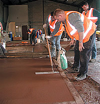 Lafarge UK Spring Training troweling the edge of colored concrete.