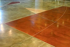 Acid stain with graphic tape on a polished concrete floor. The graphic tape is used to give movement to a symmetrical floor. 