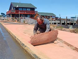 Bandon Boardwalk Construction - Brock went with shake-on instead of integral color because he wanted to maintain color control on a job that ultimately took eight to 10 pours to finish. With integral colors and multiple pours, you really have to be on the ball with mix design, he says. To me, there were just too many variables.