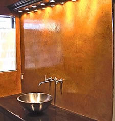 Bathroom wall featuring vertical concrete overlay with sink and countertop