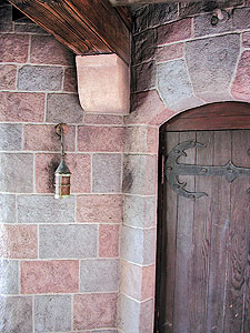 Entryway stamped vertical concrete overlay similar to a castle wood door and stone blocks in multiple stain concrete colors.