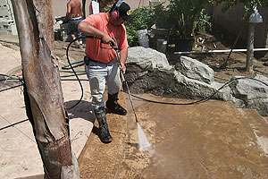 Rinsing of concrete Liquid Release Agent from a cured concrete slab with a pressure washer.