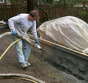 Mike Dahl applying shotcrete - The structure itself is created by applying the shotcrete to an adequate depth, and just about everyone will tell you the most important guy on the crew is the nozzle man.
