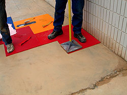 Compared to stamping a new concrete surface, tamping a pattern onto an overlay requires less force. In fact, tampers for stamping an overlay are larger at the base so as to displace some of the force of the pounding over a larger area