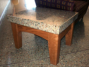 Polishing Concrete RetroPlated, exposed river rock table top matches the floor. Photo courtesy of Stephens & Smith Construction.
