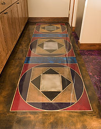 permanent area rug on a concrete floor stained in circles and triangles.