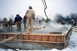 Smoothing concrete after the warm water concrete has been placed in this cold weather environment.
