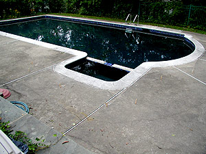 A pool deck before resurfacing.