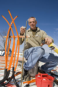 Bob Hot Rod Rohr installs radiant heat equipment on an under-concrete job in Branson, Mo.