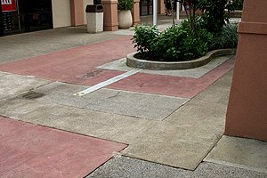 Before the restoration, concrete at the Kukui Grove Center had many different haphazardly arranged finishes and patches.