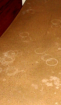 Concrete countertop that has been stained with cup rings because it was not maintained properly.