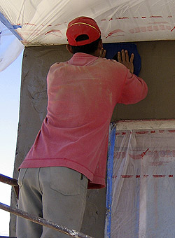 Applying the wall finish using shotcrete and pressure
