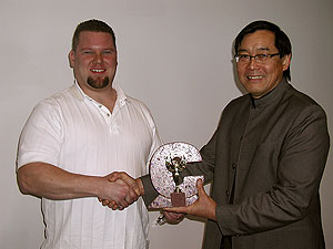 Gregory Mata receives an award from Fu Tung Cheng for excellence in concrete.