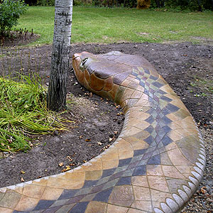 A look at the back of the snake with its geometric scales that were created with stamping, scoring and staining the concrete.