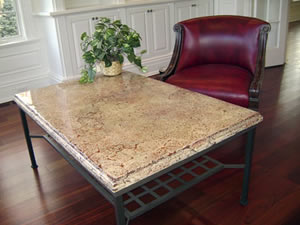 Wrought iron table topped with a concrete countertop cream and red