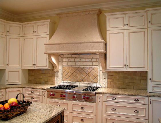 Kitchen range hood that blends naturally into the kitchen of light colored granite.
