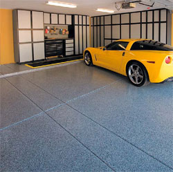 A yellow corvette sits on a newly installed garage floor epoxy system.