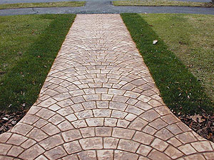 Stamped concrete walkway with radial stamp pattern.