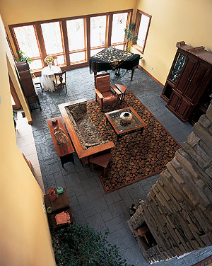 Workers created a stone-tile appearance on this living room floor by pressing the tile pattern into a cementitious overlay that was installed at 3/8-inch thick. Photo courtesy of Bomanite Corp.