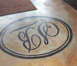 Stenciled and stained concrete logo on the floor.