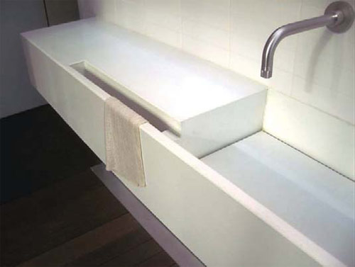 Integral Sink: John Newbold, Newbold Stone Architectural Concrete, Austin, Texas Minimalist white sink with integrated towel holder
