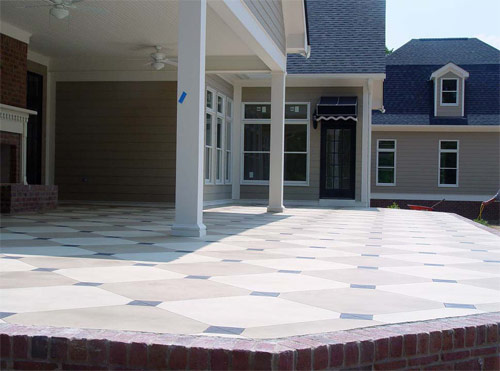 stamped concrete patio outside a hole with brick-like edge made with concrete
