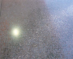 This integrally colored concrete floor was embedded with crushed glass, mother-of-pearl and slate rock. It was densified with a lithium densifer and polished to 3,000 grit. Photo courtesy of The Decorative Concrete Institute