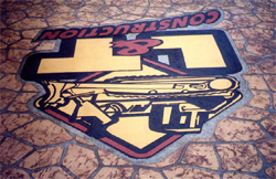 The finished L&T logo on the driveway, shown upside down, as seen from the house.